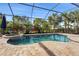 Enclosed pool and spa with patio and lush landscaping at 7004 Highgate Ln, Bradenton, FL 34202