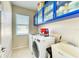 Bright laundry room with washer, dryer, and ample storage at 11315 77Th E St, Parrish, FL 34219