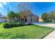 Two-story home with a three-car garage and manicured lawn at 11315 77Th E St, Parrish, FL 34219