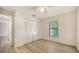 Well-lit bedroom featuring wood-look floors and a double door closet at 8212 Country Oaks Ct, Sarasota, FL 34243