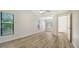 Spacious bedroom with wood-look floors and access to bathroom at 8212 Country Oaks Ct, Sarasota, FL 34243