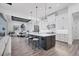 Modern kitchen with island, stainless steel appliances, and white cabinetry at 7924 Redonda Loop, Lakewood Ranch, FL 34202