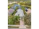 Aerial view of a single-Gathering home with a paved driveway and lush landscaping at 12121 Thornhill Ct, Lakewood Ranch, FL 34202