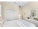 Bedroom with queen bed, white bedding, and a ceiling fan at 12121 Thornhill Ct, Lakewood Ranch, FL 34202