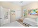 Bedroom with twin beds, ceiling fan, and adjacent bathroom at 12121 Thornhill Ct, Lakewood Ranch, FL 34202