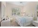 Bright bedroom with a queen bed, white bedding, and a ceiling fan at 12121 Thornhill Ct, Lakewood Ranch, FL 34202