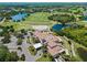 Aerial view of the community clubhouse, golf course, and surrounding landscape at 12121 Thornhill Ct, Lakewood Ranch, FL 34202