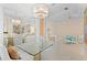 Bright dining room with a glass-top table and white chairs at 12121 Thornhill Ct, Lakewood Ranch, FL 34202