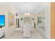 Elegant dining room features a glass table, white chairs, and a large mirror at 12121 Thornhill Ct, Lakewood Ranch, FL 34202