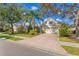 Single-Gathering house with a brick driveway and lush landscaping at 12121 Thornhill Ct, Lakewood Ranch, FL 34202