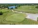Aerial view of a lush golf course with a lake and practice area at 12121 Thornhill Ct, Lakewood Ranch, FL 34202