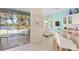 Bright kitchen features granite countertops, white cabinets, and stainless steel appliances at 12121 Thornhill Ct, Lakewood Ranch, FL 34202