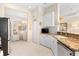 Modern kitchen with white cabinets, granite countertops, and a breakfast bar at 12121 Thornhill Ct, Lakewood Ranch, FL 34202