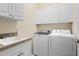 Laundry room with washer, dryer, cabinets and sink at 12121 Thornhill Ct, Lakewood Ranch, FL 34202