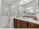 Bathroom with glass-enclosed shower, marble counters, and ample cabinet storage at 317 Acerno Dr, North Venice, FL 34275