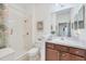 Clean bathroom with a shower-tub combo, stylish vanity and ample lighting at 317 Acerno Dr, North Venice, FL 34275