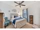 Comfortable bedroom with ceiling fan, neutral tones, and a decorative chair at 317 Acerno Dr, North Venice, FL 34275