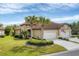 Stunning single-story home with manicured lawn, tile roof, and three-car garage at 317 Acerno Dr, North Venice, FL 34275
