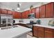 The well-lit kitchen features stainless steel appliances, wood cabinets, and a spacious center island with a sink at 317 Acerno Dr, North Venice, FL 34275