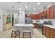 Modern kitchen with stainless steel appliances, an island with seating, and ample cabinet space at 317 Acerno Dr, North Venice, FL 34275