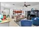 Open-concept living area with tile floors, ceiling fan, and view of the modern kitchen at 317 Acerno Dr, North Venice, FL 34275