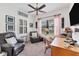 A well-lit home office featuring plush seating, modern decor, and a serene view from the window at 317 Acerno Dr, North Venice, FL 34275