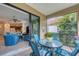 Covered patio with outdoor dining set adjacent to open living area at 317 Acerno Dr, North Venice, FL 34275