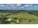 Aerial view showcasing a home on a large lot with a pool and outbuildings at 6930 69Th E St, Palmetto, FL 34221