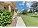 Side walkway of a one-story house with lush landscaping at 6930 69Th E St, Palmetto, FL 34221