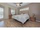 Main bedroom with wood floors, a large bed, and access to a pool at 6930 69Th E St, Palmetto, FL 34221