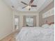 Main bedroom with wood floors, large bed, and sliding glass doors to patio at 6930 69Th E St, Palmetto, FL 34221
