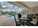 Relaxing pool area with patio furniture under screened enclosure at 6930 69Th E St, Palmetto, FL 34221