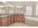 Elegant bathroom with double vanity, soaking tub, and large mirror at 6930 69Th E St, Palmetto, FL 34221