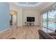 Relaxing living room with hardwood floors, a view of the pool, and recessed lighting at 6930 69Th E St, Palmetto, FL 34221