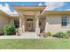 Front entrance of a one-story house with columns and landscaping at 6930 69Th E St, Palmetto, FL 34221