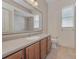 Clean bathroom with wood cabinets, a large mirror and tiled floors at 6930 69Th E St, Palmetto, FL 34221