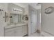 Clean bathroom with single sink vanity, and linen closet at 634 Schooner St, North Port, FL 34287