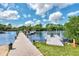 Wooden community dock with multiple boats and floating dock at 634 Schooner St, North Port, FL 34287