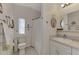 Bathroom with toilet, shower, single sink vanity, and mirror at 634 Schooner St, North Port, FL 34287