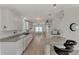 Modern kitchen with white cabinets, granite counters, and stainless steel appliances at 634 Schooner St, North Port, FL 34287