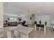 Open kitchen with granite counters and adjacent dining area with glass top table at 634 Schooner St, North Port, FL 34287