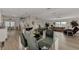 Open concept kitchen and living area with granite counters and light flooring at 634 Schooner St, North Port, FL 34287