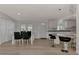 Dining area with glass table and four chairs adjacent to kitchen at 634 Schooner St, North Port, FL 34287