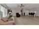 Living area with light flooring, comfortable seating, and built-in shelving at 634 Schooner St, North Port, FL 34287