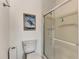 Bathroom with toilet, shower, and a framed picture at 634 Schooner St, North Port, FL 34287