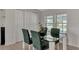 Dining area with glass table and four chairs near built-in shelving at 634 Schooner St, North Port, FL 34287