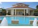 Community pool with a clubhouse and fountains at 1135 Villagio Cir # 204, Sarasota, FL 34237