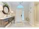 Bright foyer with decorative mirror and console table at 12715 Lake Silver Ave, Bradenton, FL 34211
