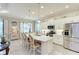 Modern kitchen with white cabinets, stainless steel appliances, and a large island at 12715 Lake Silver Ave, Bradenton, FL 34211