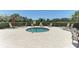 Circular hot tub surrounded by lounge chairs in a community setting at 12715 Lake Silver Ave, Bradenton, FL 34211